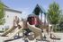 Playground structure in sand-pit with 5 slides and various climbing structures