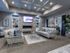 Clubhouse waiting room with 2 couches, flat screen television, fireplace, desk, 2 chairs, and coffee table