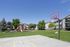 Two-Bedroom Apartments in Ogden, UT - Pinebrook - Half Basketball Court Surrounded by a Grass Area, Overlooking the Playground, Trees, and Apartments.