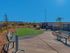 Dog park with 2 benches and grass area