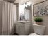 Pet-Friendly Townhomes in West Jordan, UT - Carrington Square - Modern Bathroom With Granite Vanity, Framed Mirror, Light Fixtures, Shower Curtain, and Wall Art.