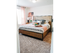 Master bedroom with queen bed, large window, and 2 nightstands