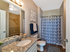 Master bathroom with sink vanity, toilet, tub/shower combo, and walk-in closet entrance