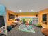 2 level playroom with toys, slide, and TV
