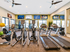Townhomes with attached Garage in St. George, UT - Grayhawk Apartments at River's Edge - Fitness Center With Treadmills, Ellipticals, Free Weights, Wall Mounted Screens, And Large Windows.