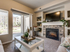 Living room with built in entertainment center shelving and fireplace and sliding glass door to patio area