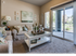 2-Bedroom Apartments in Meridian, ID - The Regency at River Valley - Cozy Living Room With Plush Sofa, White Coffee Table Decor, Soft Carpet, And Sliding Glass Door To Covered Patio.