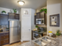 View over the breakfast bar of fridge/freezer and walk-in pantry