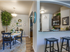 Archway from kitchen to dining room showing 4 person oval dining table and console table