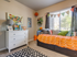 Pet-Friendly Apartments in Meridian, ID - Regency at River Valley - Second Bedroom Featured as Children&rsquo;s Room, with Carpet Flooring, Twin Bed with Built-in Storage Drawers, White Dresser, Wall Arts, Toys, Rug, and Large Window with Curtain and Blinds.