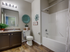 Guest bathroom with vanity and sink, toilet, and tub/shower combo