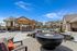 Firepit in outdoor pool areas with patio furniture and hot tub in background