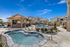 Three-Bedroom Apartments in Twin Falls, ID - Rivercrest - Hot Tub Overlooking the Grilling Stations, Swimming Pool, Lounge Chairs with Umbrellas, and Apartments.