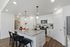 Twin Falls, ID, Studios for Rent - Rivercrest - Modern Kitchen With Speckled Island Countertop, Bar Seating, White Cabinetry, Pendant Lighting, And Stainless Steel Appliances.