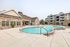Luxury Apartments in Nampa, ID with In-Unit Washer and Dryer - The Station at Gateway - Swimming Pool with Sundeck, Sunbeds, and Umbrellas.