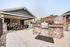 Two-Bedroom Luxury Apartments in Nampa, ID - The Station Apartments at Gateway -Grilling Area With Stone Built-In Barbecue, Covered Dining Seating, And Poolside Umbrellas.