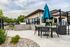 Apartments Near Jordan Landing - Carrington Square - BBQ Area with Grilling Station and Umbrella Table with Chairs.