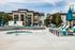 Pet-Friendly Apartments in Kearns, UT - Carrington Square - Swimming Pool with Hot Tub, Spacious Sundeck, Lounge Chairs, Pergola, and Patio Umbrellas.