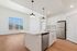Nampa, ID, Luxury Apartments for Rent - The Station Apartments at Gateway - Kitchen With Large Island, Pendant Lights, Stainless Steel Appliances, And Wood Look Flooring.