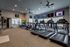 Fitness center with 3 treadmills, 2 stationary bikes, elliptical, and 4 flat screen televisions