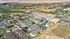 Expansive aerial view of a picturesque apartment complex nestled amidst lush greenery and striking canyon landscapes.