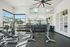 Bright and modern fitness center with state-of-the-art gym equipment and large windows for natural light.