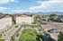 Charming residential area with green courtyard, modern architecture, and stunning mountain views.