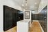 Modern apartment mailroom with sleek black mailboxes, stylish hardwood floors, and bright lighting.