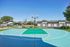 Vibrant outdoor basketball court with a scenic mountain backdrop, nestled in a modern residential community.
