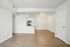 Contemporary apartment interior featuring open floor plan with sleek kitchen, modern lighting, and elegant hardwood floors.