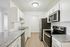 Modern kitchen with sleek stainless steel appliances, elegant white cabinetry, and polished granite countertops.