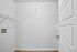 Bright utility room with ample shelving space, perfect for storage and organization in a modern apartment.