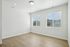 Bright and inviting empty room with large windows and elegant wood flooring, ideal for personalizing your dream space.