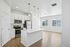 Modern kitchen with sleek white cabinetry, stainless steel appliances, and an inviting island illuminated by stylish pendant lighting in a bright, open-concept space.