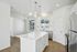 Modern kitchen with sleek white cabinetry, stainless steel appliances, and elegant pendant lighting, creating a bright and inviting atmosphere.