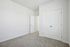 Bright and spacious room featuring clean white walls and plush carpet flooring, perfect for a modern living space.