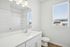 Bright and modern bathroom with sleek fixtures, spacious countertop, and natural light from a large window.