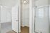 Bright, contemporary bathroom featuring a sleek glass shower, spacious walk-in closet, and modern fixtures.