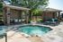 Charming outdoor space with a relaxing hot tub surrounded by elegant seating areas and lush greenery.