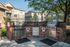 Inviting outdoor grill area with modern appliances and brickwork, nestled in a picturesque apartment community.