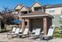 Elegant apartment complex with stylish outdoor lounging area and inviting poolside ambiance.