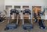Modern fitness center featuring state-of-the-art treadmills and exercise bikes, offering a spacious and invigorating workout environment.