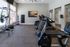Bright and inviting fitness center with modern treadmills, stationary bike, and yoga equipment, perfect for an energizing workout.