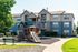 Charming apartment complex with modern design and a vibrant playground, nestled in lush greenery for family-friendly living.