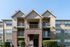Charming apartment building with a classic brick facade, featuring spacious balconies and well-maintained landscaping.