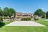 Charming apartment community with a lush green courtyard and a private basketball court, perfect for active living.