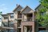Charming apartment complex with modern architecture, featuring private balconies and lush greenery.