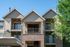 Charming apartment building with modern architectural design, featuring spacious balconies and lush greenery.
