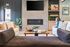 Modern living room with cozy sofas, stylish fireplace, and elegant decor, perfect for relaxed gatherings.