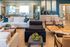 Inviting living room with modern furniture, chic decor, and a stunning natural wood coffee table, perfect for luxurious relaxation.